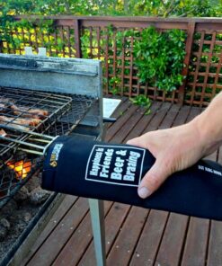 The braai grid handle sleeve / sock over the braai grid - close up being held by a hand